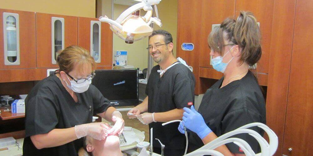 Dr. Derek B. Hauser, DDS, and his Registered Dental Assistants